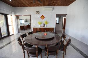 a dining room with a table and chairs at Naisoso Island Villa - Fiji in Nadi