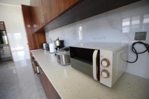 a white toaster oven on a counter in a kitchen at Naisoso Island Villa - Fiji in Nadi