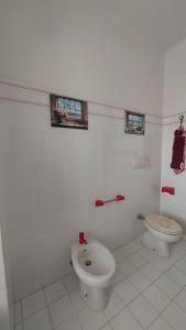 a white bathroom with a toilet and a bidet at Nonna Liliana in San Lorenzo al Mare