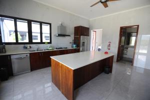 a kitchen with a island in the middle of it at Naisoso Island Villa - Fiji in Nadi