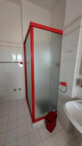 a bathroom with a glass shower and a sink at Nonna Liliana in San Lorenzo al Mare +5 photos