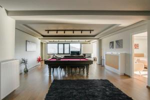 a living room with a pool table in it at Elysian Villa by Ski Alure in Arachova