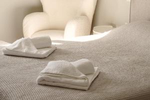two towels sitting on top of a bed at Elysian Villa by Ski Alure in Arachova +39 photos