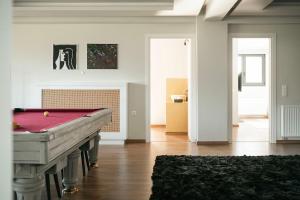 a living room with a pool table in it at Elysian Villa by Ski Alure in Arachova