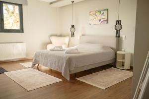 a bedroom with a bed with two rugs at Elysian Villa by Ski Alure in Arachova