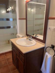 un bagno con lavandino e specchio di La Paidera de Cutanda 