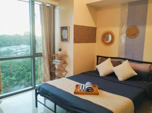 a bedroom with a bed and a large window at BGC Mckinley City Center Apartments - Global City in Manila +61 photos