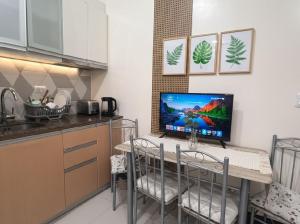 a kitchen with a table with a computer on it at BGC Mckinley City Center Apartments - Global City in Manila