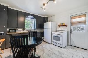 a kitchen with a table and a white refrigerator at Lafayette Private Room-shared Kitchen free and Parking in Lafayette
