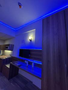 a room with a blue lighting in a kitchen at Crown Suites in Greater Noida