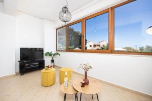 a living room with a table and a large window at Villa Aspa in Prinés
