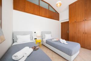 two twin beds in a room with wooden cabinets at Villa Aspa in Prinés +33 photos