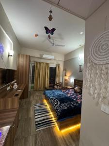 a bedroom with a bed with butterflies on the ceiling at Crown Suites in Greater Noida