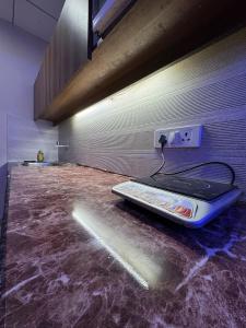 a room with a machine sitting on the floor at Crown Suites in Greater Noida +24 photos