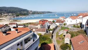 a view of a town with a beach and houses at Apartamento en Aldán , Playa a 2 min , Vistas a la montaña in Aldán
