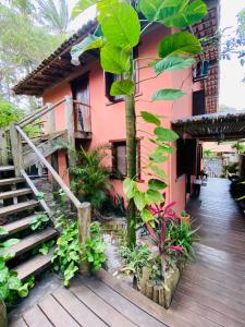 a building with stairs and plants in front of it at Pousada Lumawê Caraíva in Porto Seguro