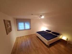 a bedroom with a bed and a window at Helle, großzügige Dachgeschosswohnung in Aichtal 