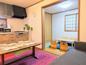 a living room with a table and a kitchen at Wood River House 門前仲町駅 木場駅 in Tokyo