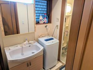 a bathroom with a sink and a washing machine at Wood River House 門前仲町駅 木場駅 in Tokyo +39 photos