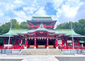 a large building with red columns and a roof at Wood River House 門前仲町駅 木場駅 in Tokyo