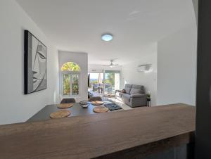 a living room with a table and a couch at Coral Bay Star - Direct sea location in Peyia +24 photos