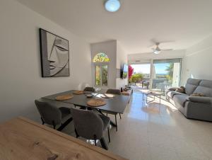 a living room with a table and chairs and a couch at Coral Bay Star - Direct sea location in Peyia
