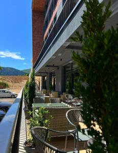 a patio with chairs and tables and a building at Charmy mountain suite in hotel Phoenix in SJJ