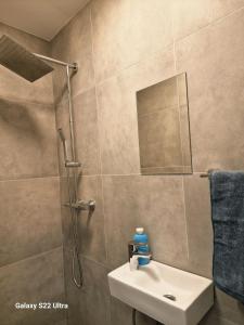 a bathroom with a shower and a sink and a mirror at RentA Citywalk Flat in Kaunas +31 photos