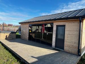 a small building with a wooden deck at Cornatel Relax Village in Cornăţel