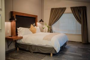 Ένα ή περισσότερα κρεβάτια σε δωμάτιο στο Tierra Mia Hacienda Ruta del Vino