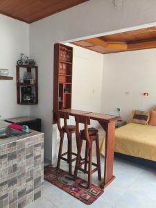 a kitchen with a table and a bed in a room at beautiful and cozy studio apartment in San Martín
