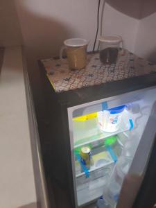 a small refrigerator with a counter on top of it at beautiful and cozy studio apartment in San Martín