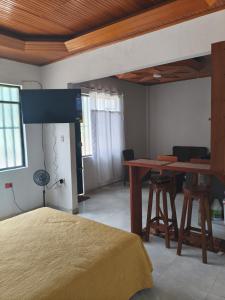 a bedroom with a bed and a desk and a table at beautiful and cozy studio apartment in San Martín