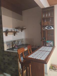 a small kitchen with a table and a sink at beautiful and cozy studio apartment in San Martín +3 photos