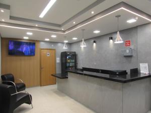 a lobby with a bar with a tv on the wall at Las Vegas Hotel in São Paulo +35 photos