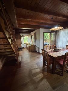 a dining room with a table and a living room at Ayrampo in Mar de las Pampas +31 photos