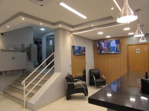 a waiting room with chairs and a staircase at Las Vegas Hotel in São Paulo