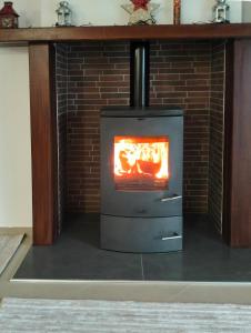 a brick fireplace with a stove in a room at Chloe Maxi Apt 108 sqm in Kastoria