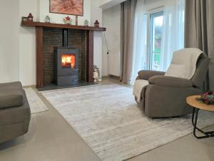 a living room with a couch and a fireplace at Chloe Maxi Apt 108 sqm in Kastoria