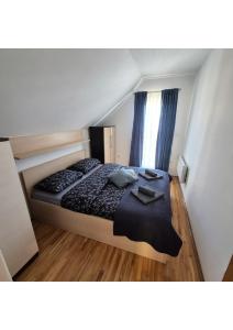 a bedroom with a bed with a black comforter at Holiday home Maša - Kupres in Kupres
