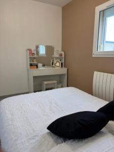 a bedroom with a bed with a pillow on it at chambre sur le circuit des 24h du Mans in Ruaudin