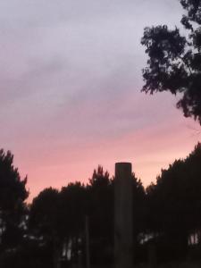 Een silhouet van een silo bij zonsondergang bij ChicPDD in Punta Del Diablo