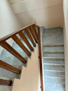 a staircase in a house with wooden railings at 2-Room Apartment in Jaffna