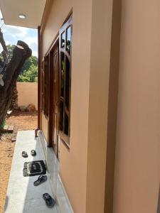 a room with a window and a pair of shoes on the floor at 2-Room Apartment in Jaffna