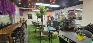 a restaurant with tables and chairs and a bar at Charming Country Retreat with Scenic Views for 1 - 12 guests in Sainte-Marguerite