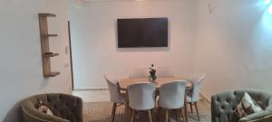 a dining room with a table and chairs at Rabat in Temara