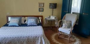 Chambre d'hôtes Le Devezou في سانت أفريك: غرفة نوم بها سرير وكرسي