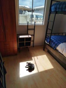 a bedroom with a bunk bed and a window at Hostal Yei, Punta Arenas in Punta Arenas