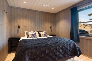 a bedroom with a bed and a window at Trysilfjell hytteomrade 2124 by Vacation Trysil in Hovi +11 photos