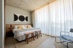 Postel nebo postele na pokoji v ubytování CasaChica Hotel